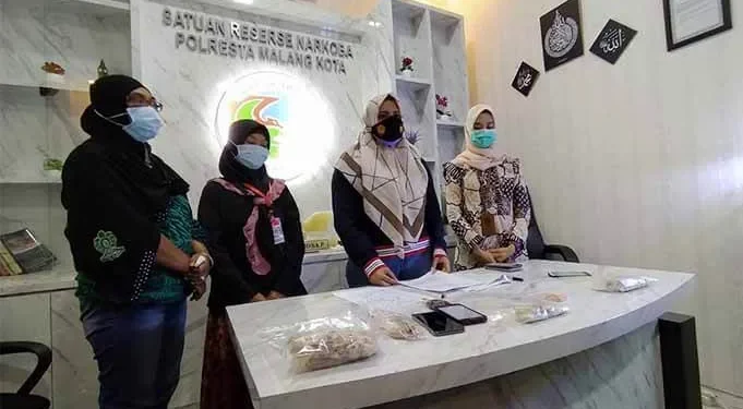 Kasatreskoba Polresta Malang Kota, Kompol Anria Rosa Piliang (no dua dari kanan) dan Mamik Winarsih, yang mengirimkan tembakau ke anaknya (no 2 dari kiri) saat menyampaikan keterangan di Mapolresta Kota Malang.
