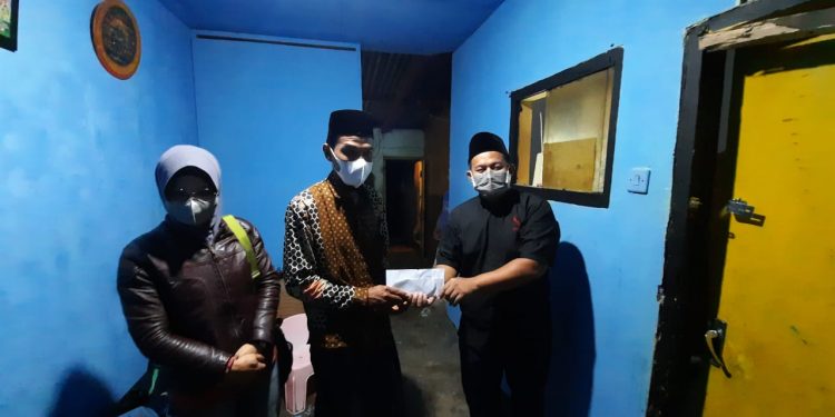 Wakil Fraksi PKS DPRD Kota Malang, Trio Agus Purwono, menyalurkan bantuan uang tunai di rumah Siswoyo, pada Sabtu (21/8/2021) malam. . Foto: dok PKS
