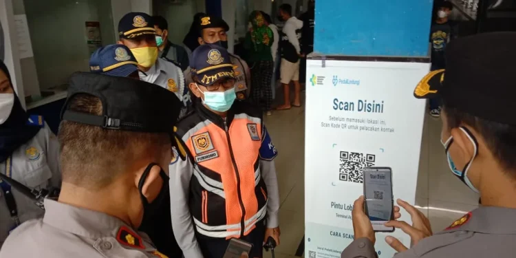Wakapolresta Malang Kota, AKBP Deny Heryanto bersama Kabag Ops Polresta Malang Kota, Kompol Supiyan mengecek aplikasi PeduliLindungi di Terminal Arjosari. Foto: M Sholeh