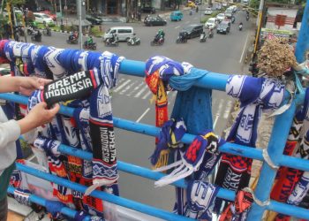 Aksi simpatik suporter gantung syal di Jembatan penyeberangan di wilayah Kecamatan Blimbing, Kota Malang, sebagai respon atas penegakan hukum peristiwa kelam di Stadion Kanjuruhan 1 Oktober 2022 itu.