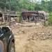 Material tanah longsor menutupi akses jalan desa.