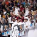 Para penduduk Qatar saat melakukan aksi tutup mulut sambil menunjukkan poster Mesut Ozil di Al Bayt Stadium.