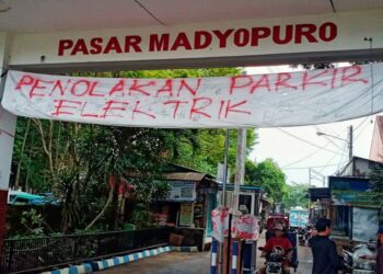 Spanduk penolakan atas rencana penerapan E-Parking di Pasar Madtopuro, Kota Malang.
