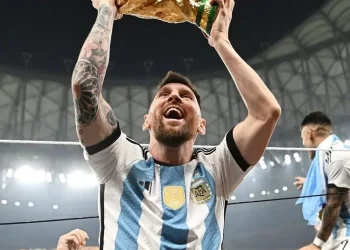 Lionel Messi saat mengangkat trofi Piala Dunia 2022 di Stadion Lusail, Minggu (18/12/22).