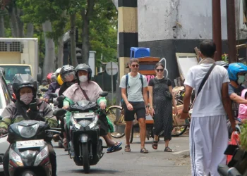 Ilustrasi wisatawan mancanegara berjalan kaki menuju destinasi dekat Stasiun Kota Malang.
