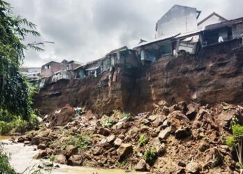 Rumah warga yang menggantung di bibir sungai yang longsor di Kota Malang