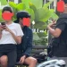 Sepasang sejoli terekam berpangkuan di kursi taman Jalan Besar Ijen, Kota Malang.