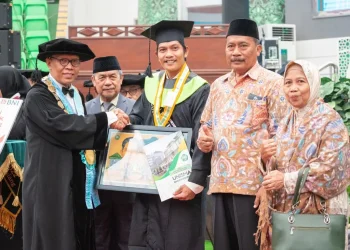 Rektor Unisma, Prof Dr Maskuri (kiri), saat memberikan cindera mata kepada wisudawan terbaik.