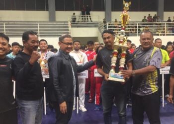 Pj Wali Kota Batu, Aries Agung Paewai, menyerahkan Piala Wali Kota Kejurprov Gulat Jatim kepada atlet Kota Batu.