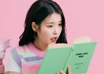 Aktris IU tampak sedang membaca buku.