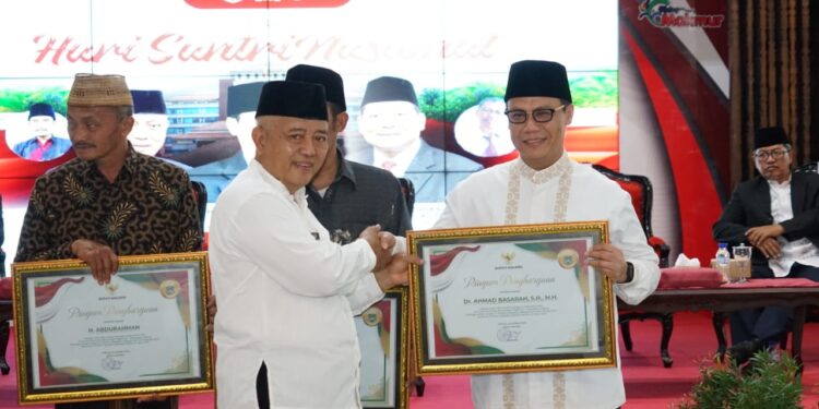 Bupati Malang, Sanusi memberikan penghargaan pada Ahmad Basarah, salah satu tokoh pengusul Hari Santri Nasional.