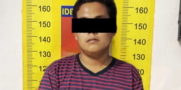 Tersangka RA usai diamankan Polsek Tumpang.