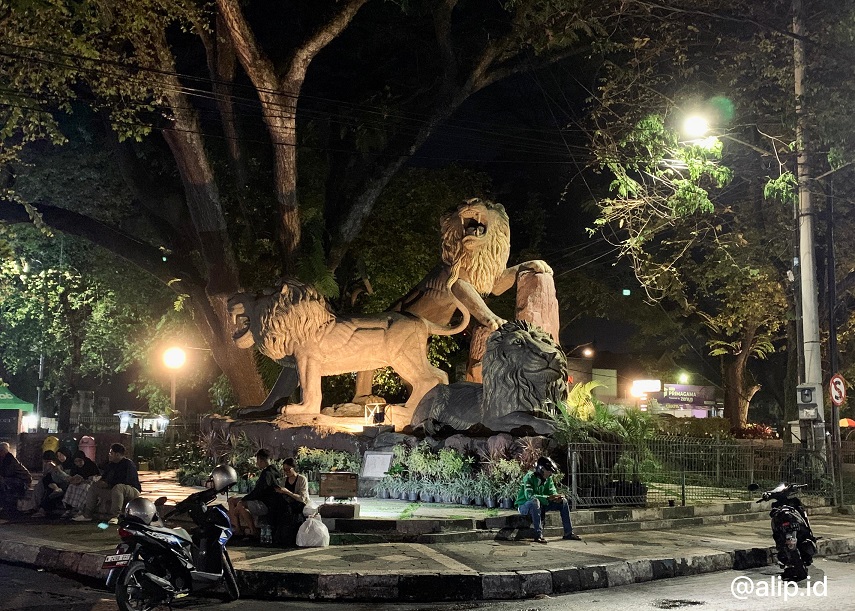 Gambar monumen Tiga singa pada malam hari, yang menjadi simbol bersatunya tiga kepala daerah di Malang Raya.