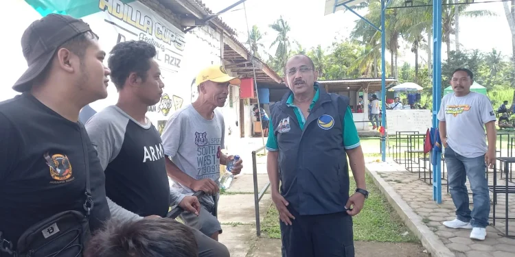 Djamal Aziz (memakai rompi) berdialog dengan peserta lomba burung berkicau.