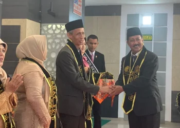 Prosesi pengalungan selempang oleh Dekan FKIP, Dr Hasan Busri MPd,  kepada peserta guru profesional di acara yudisium dan pembekalan PPG FKIP Unisma