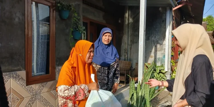 Respon antusias warna menerima paket sembako yang dibagikan oleh mahasiswa Fakultas Vokasi UMM. Foto / dok