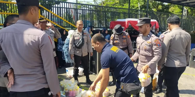 Petugas RS Hasta Bratha Kota Batu membagikan nutrisi berupa susu dan vitamin kepada petugas Sispamkota Polres Batu. Foto: Azmy