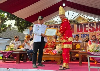 Bupati Malang, Sanusi memberikan bantuan dana untuk bersih desa kepada Kepala Desa Sukoanyar, Sersan Mayor (Purn) Santosa. Foto: Aisyah Nawangsari Putri