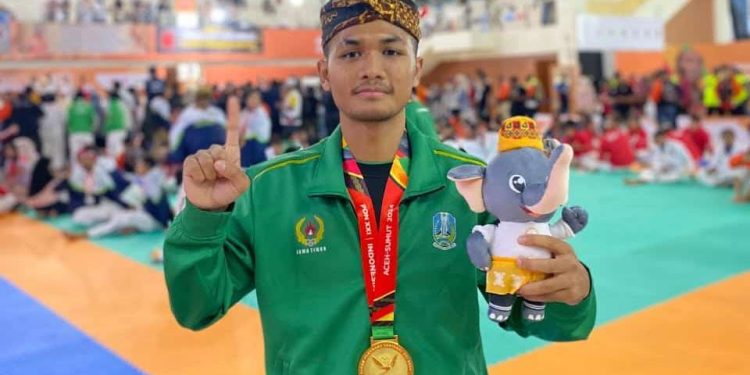Aryo Pandu Pamungkas, atlet Kota Batu, memamerkan medali emas yang baru saja ia peroleh di PON 2024. Foto: KONI Kota Batu