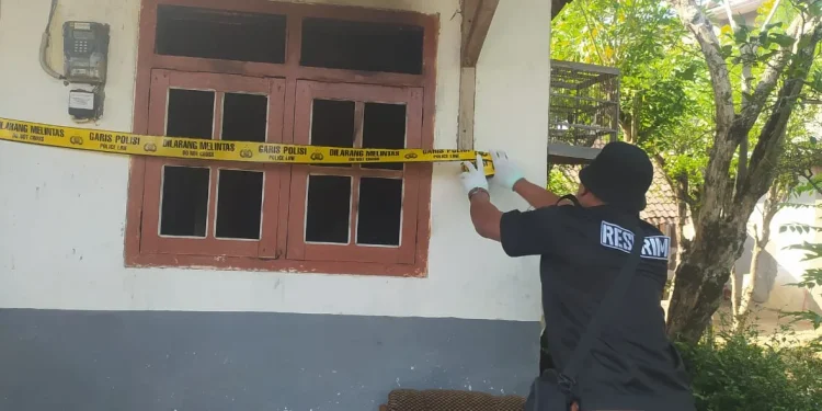 Petugas memasang garis polisi di TKP adik bakar kakak di Tirtoyudo. Foto: Polres Malang
