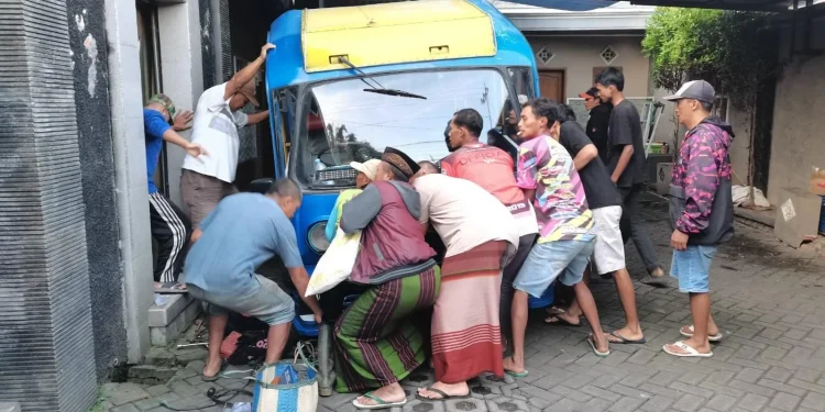 Proses evakuasi mengeluarkan badan montir yang tertimpa kendaraan. Foto: Polres Batu
