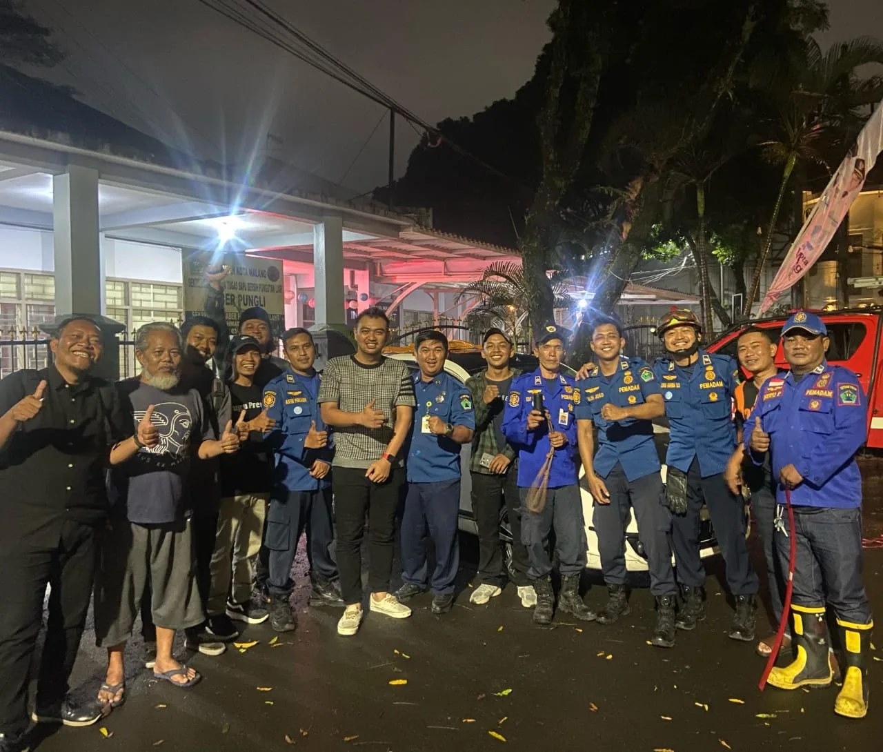 Petugas damkar berfoto bersama pemilik mobil. Foto/dok