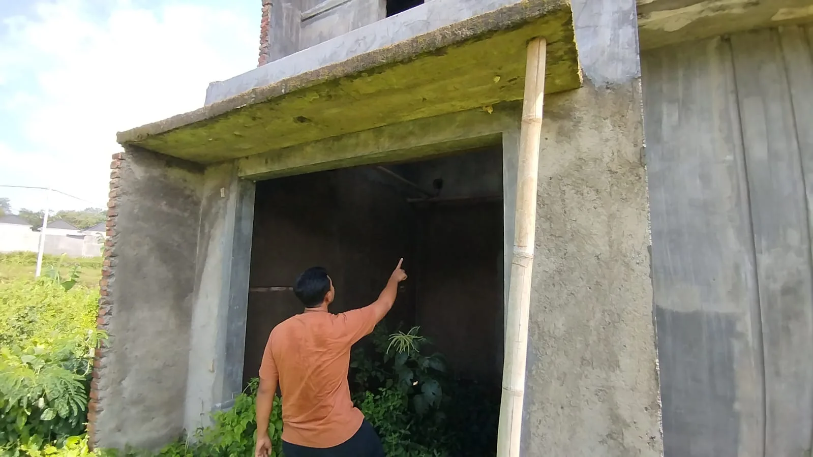Seorang warga menunjukkan pembangunan rumahnya yang mangkrak. Foto: dok. Warga
