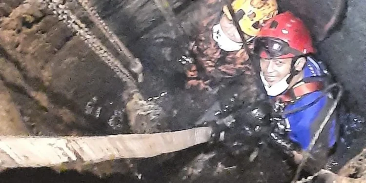 Petugas turun ke dalam septictank untuk evakuasi sapi. Foto: Damkar Kabupaten Malang