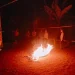 Petugas membakar kurungan ayam yang ditemukan di lokasi judi sabung ayam. Foto: Polres Malang