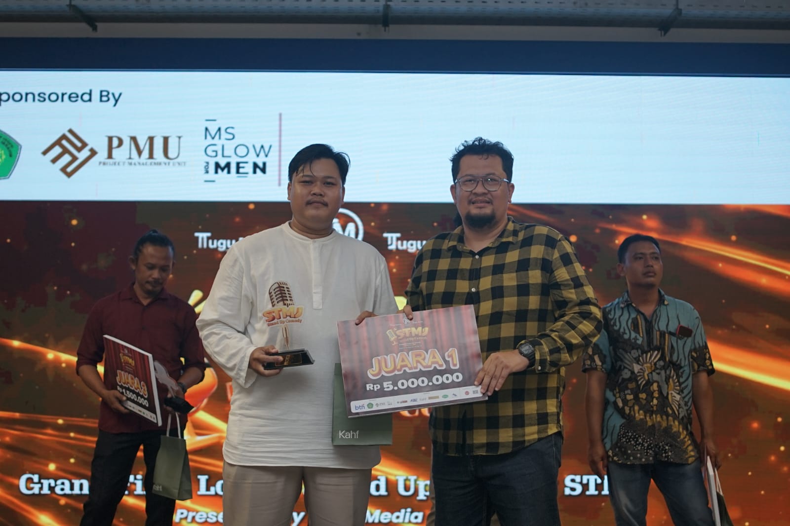 CEO Tugu Media Group, Irham Thoriq menyerahkan penghargaan Juara STMJ 2026 kepada Rifqi Elmo (dok. TugumalangID)