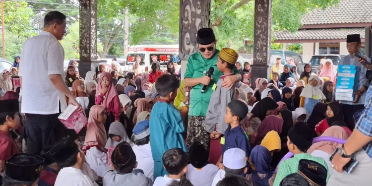 Iwan Kurniawan (baju hijau) berdialog dengan anak yatim. Foto: Aisyah Nawangsari Putri