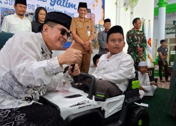 Komut PT ACA, Iwan Kurniawan (kiri) memberi hadiah mobil mainan aki kepada Wafi Mafaza. Foto: Aisyah Nawangsari Putri